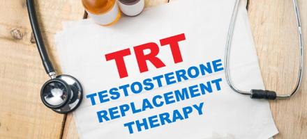 Looking down at a poster about Testosterone Replacement Therapy surrounded by a sample of cannabis products and a medical stethoscope,